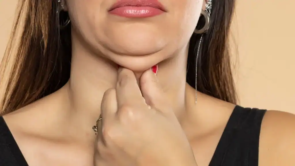 An image of a woman with double chin, sad, worried : Non Surgical Double Chin Removal Treatment in Broxburn, UK