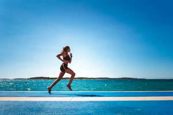 Woman running showing strong leg muscle Broxburn